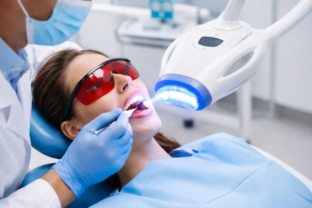 Close up of Zoom Teeth Whitening treatment with whitening gel and LED light in dental clinic