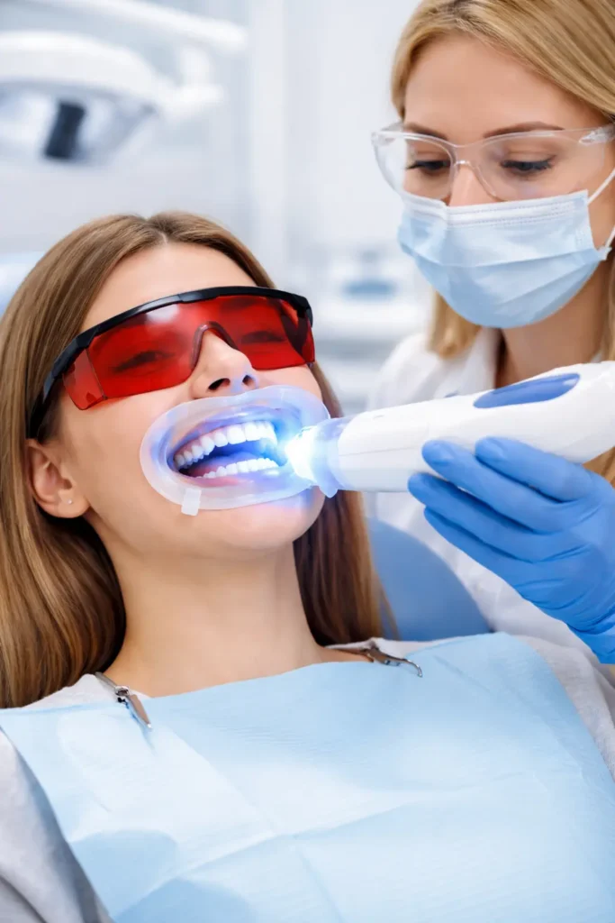 Doctor whitening procedure performed by dentist using LED teeth whitening treatment